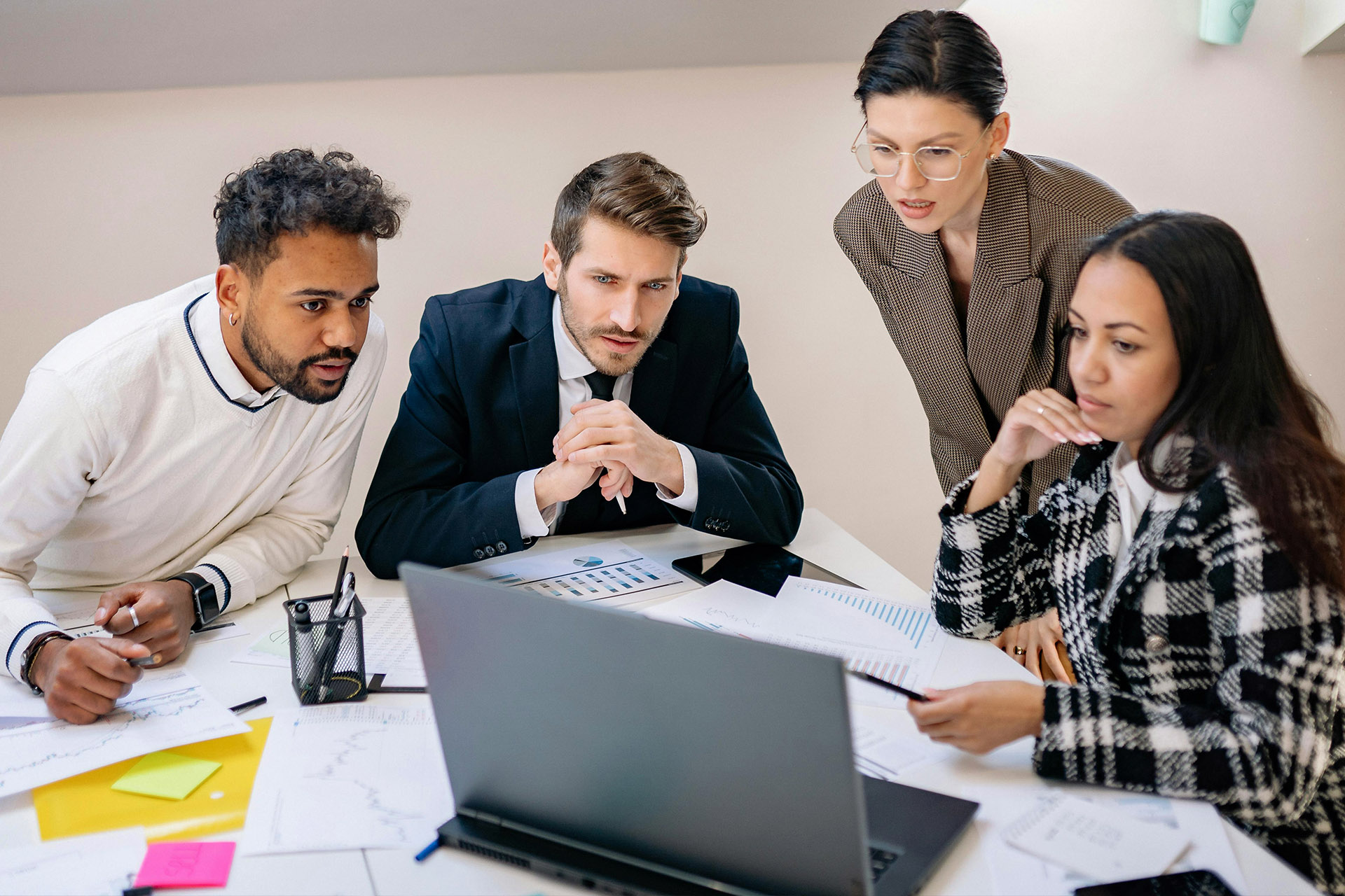 Smiling team leader with employees listening to businesswoman at corporate meeting, sitting in modern boardroom, happy colleagues partners discussing project strategy, sharing startup ideas